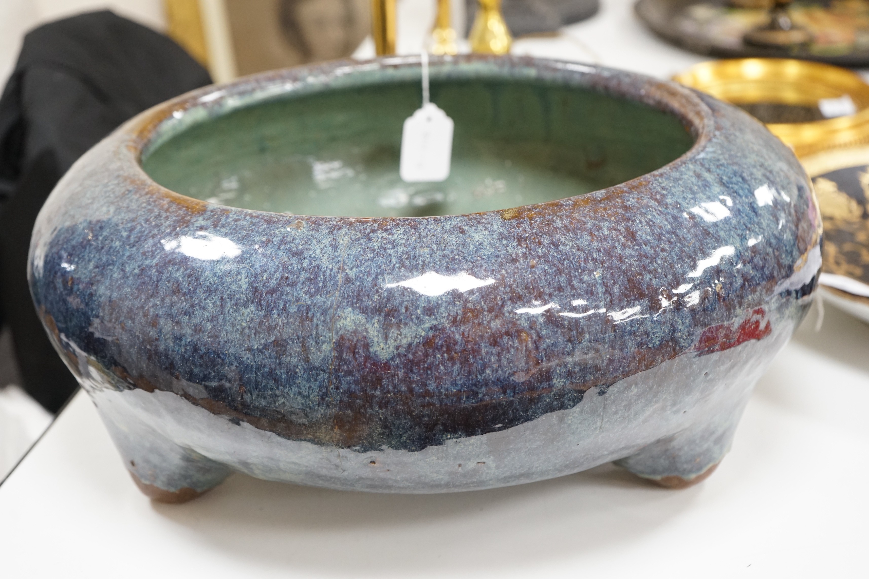 A large Chinese Shiwan stoneware tripod vessel or censer, late 19/early 20th century, 47cm diameter